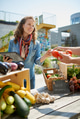 Friendly woman tending an organic vegetable stall at a farmer's market and selling fresh vegetables. Friendly woman tending an organic vegetable stall at a farmer's market and selling fresh vegetables. - PhotoDune Item for Sale