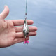 The hand of a male fisherman holds a metal tackle on a predator close-up. Fishing. The hand of a male fisherman holds a metal tackle on a predator close-up. Fishing. - PhotoDune Item for Sale