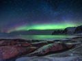 Tungeneset rocks and Aurora Borealis light. Stars trails and northern light. Norway Tungeneset rocks and Aurora Borealis light. Stars trails and northern light. Norway - PhotoDune Item for Sale