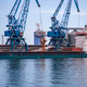 Cranes Loading Grain into a Large Cargo Ship Cranes Loading Grain into a Large Cargo Ship - PhotoDune Item for Sale