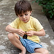 a cute four-year-old boy is sitting on the asphalt and playing a cute four-year-old boy is sitting on the asphalt and playing - PhotoDune Item for Sale
