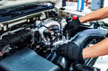 Auto mechanic working with open car hood in garage. Car repair service. Auto mechanic working with open car hood in garage. Car repair service. - PhotoDune Item for Sale