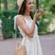 African American woman in white dress records audio message on smartphone. adorable female model African American woman in white dress records audio message on smartphone. adorable female model - PhotoDune Item for Sale