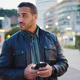 Portrait of confident man using smartphone standing on the evening city street Portrait of confident man using smartphone standing on the evening city street - PhotoDune Item for Sale