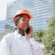 Serious black woman in helmet talking on smartphone in daylight Serious black woman in helmet talking on smartphone in daylight - PhotoDune Item for Sale