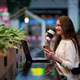 Smiling brunette girl drinking coffee from a mug, working on a laptop and holding a phone in her han Smiling brunette girl drinking coffee from a mug, working on a laptop and holding a phone in her han - PhotoDune Item for Sale
