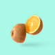 Cut kiwi fruit and inside an orange. Joke minimal pop art surprise fun poster. Cut kiwi fruit and inside an orange. Joke minimal pop art surprise fun poster. - PhotoDune Item for Sale