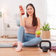 Woman taking a break after home workout, sitting on yoga mat with dumbbells, kettlebell Woman taking a break after home workout, sitting on yoga mat with dumbbells, kettlebell - PhotoDune Item for Sale