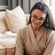 White woman drinking tea and using laptop while sitting on floor White woman drinking tea and using laptop while sitting on floor - PhotoDune Item for Sale