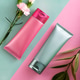 Cosmetic tubes with flowers on background Cosmetic tubes with flowers on background - PhotoDune Item for Sale