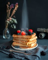 Waffles with berries with a dusting of icing sugar dusting with photo camera in the background Waffles with berries with a dusting of icing sugar dusting with photo camera in the background - PhotoDune Item for Sale