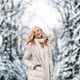 Fashion young smiling blonde woman in winter. Standing among snowy trees in winter forest. Fashion young smiling blonde woman in winter. Standing among snowy trees in winter forest. - PhotoDune Item for Sale