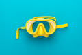 yellow diving mask over blue background with central composition yellow diving mask over blue background with central composition - PhotoDune Item for Sale