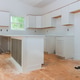 Modern kitchen renovation in progress with fresh white cabinets unfinished wooden floors Modern kitchen renovation in progress with fresh white cabinets unfinished wooden floors - PhotoDune Item for Sale