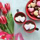 Heart-shaped chocolates and macarons with tulips and hot cocoa Heart-shaped chocolates and macarons with tulips and hot cocoa - PhotoDune Item for Sale