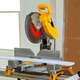 Electric saw stands on workstation in construction area with tools materials ready for cutting Electric saw stands on workstation in construction area with tools materials ready for cutting - PhotoDune Item for Sale