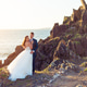 Bride and groom looking at camera on a cliff Bride and groom looking at camera on a cliff - PhotoDune Item for Sale