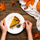 Pumpkin autumn pie on a wooden background, a piece of pie with women's hands Pumpkin autumn pie on a wooden background, a piece of pie with women's hands - PhotoDune Item for Sale