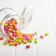 Colorful hard mint Candies in jar on white table. Colorful hard mint Candies in jar on white table. - PhotoDune Item for Sale