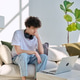 Young handsome serious guy looking at laptop screen sitting on sofa at home Young handsome serious guy looking at laptop screen sitting on sofa at home - PhotoDune Item for Sale