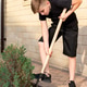 Eleven-year-old blond boy with a shovel loosens the ground under a juniper tree Eleven-year-old blond boy with a shovel loosens the ground under a juniper tree - PhotoDune Item for Sale