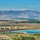 Blue irrigation reservoirs and surrounding cultivated fields against a background Blue irrigation reservoirs and surrounding cultivated fields against a background - PhotoDune Item for Sale