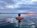 Man from behind in an infinity hot pool looking at the ocean at sunset. Sky Lagoon in Iceland Man from behind in an infinity hot pool looking at the ocean at sunset. Sky Lagoon in Iceland - PhotoDune Item for Sale