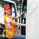Portrait young adult happy smiling woman climbing cabin heavy truck driver cargo vehicle. Portrait young adult happy smiling woman climbing cabin heavy truck driver cargo vehicle. - PhotoDune Item for Sale