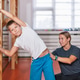 Child performing a corrective motoric flexibility exercise on wall bars Child performing a corrective motoric flexibility exercise on wall bars - PhotoDune Item for Sale