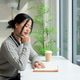 A beautiful, calm Asian woman relaxes while reading a book at a table by the window in a cafe. A beautiful, calm Asian woman relaxes while reading a book at a table by the window in a cafe. - PhotoDune Item for Sale
