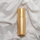 Mock up golden spray bottle for cosmetics on elegant white satin backdrop Mock up golden spray bottle for cosmetics on elegant white satin backdrop - PhotoDune Item for Sale