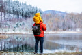 child sits on the shoulders of his father during a walk by a frozen lake in the forest child sits on the shoulders of his father during a walk by a frozen lake in the forest - PhotoDune Item for Sale