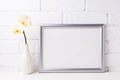 Silver landscape frame mockup with soft yellow orchid in vase Silver landscape frame mockup with soft yellow orchid in vase - PhotoDune Item for Sale