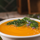 Creamy Pumpkin Soup with Fresh Spinach Garnish and Toasted Sesame Seeds Creamy Pumpkin Soup with Fresh Spinach Garnish and Toasted Sesame Seeds - PhotoDune Item for Sale
