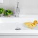 A cute little lively duckling swims in the water at home in the wash basin. A cute little lively duckling swims in the water at home in the wash basin. - PhotoDune Item for Sale