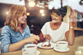 Two pretty young woman enjoying coffee Two pretty young woman enjoying coffee - PhotoDune Item for Sale