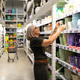 Woman engaging in thoughtful shopping experience in a vibrant home goods department of a hypermarket Woman engaging in thoughtful shopping experience in a vibrant home goods department of a hypermarket - PhotoDune Item for Sale