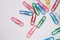 Colored paper clips close-up on a white background Colored paper clips close-up on a white background - PhotoDune Item for Sale