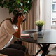 Tired young woman feeling stressed and overwhelmed while working at laptop at home Tired young woman feeling stressed and overwhelmed while working at laptop at home - PhotoDune Item for Sale