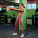 Determined sportswoman lifting kettlebell during intense workout at gym Determined sportswoman lifting kettlebell during intense workout at gym - PhotoDune Item for Sale