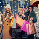 Happy young women Christmas shopping with festive lights. Happy young women Christmas shopping with festive lights. - PhotoDune Item for Sale