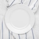 Clean white plate on fresh white towel with stripes Clean white plate on fresh white towel with stripes - PhotoDune Item for Sale