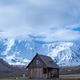 Solitary Wooden Hut with Snowy Mountain Peak Background Solitary Wooden Hut with Snowy Mountain Peak Background - PhotoDune Item for Sale