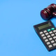 Wooden Judge Gavel next to a Calculator for Legal Costs and Fines Wooden Judge Gavel next to a Calculator for Legal Costs and Fines - PhotoDune Item for Sale