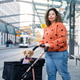 Brazilian woman pushing dog stroller waiting at tram stop Brazilian woman pushing dog stroller waiting at tram stop - PhotoDune Item for Sale