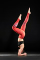 Woman working out on a yoga mat doing a headstand Woman working out on a yoga mat doing a headstand - PhotoDune Item for Sale