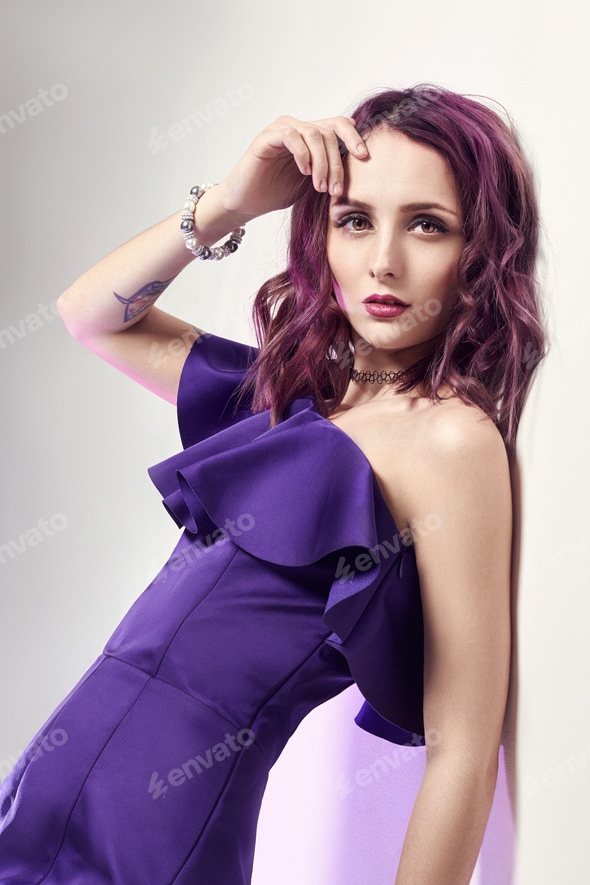 Sexy woman with purple hair and a purple dress posing near the wall. Fashion art portrait of Stock Photo by IvaFoto Sexy woman with purple hair and a purple dress posing near the wall. Fashion art portrait of Stock Photo by IvaFoto