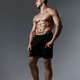 A Muscular Male Model captured in a Profile Pose with Dramatic HighContrast Lighting A Muscular Male Model captured in a Profile Pose with Dramatic HighContrast Lighting - PhotoDune Item for Sale