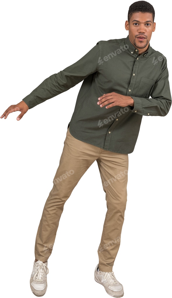 a man wearing a green shirt and khaki pants and white shoes Stock