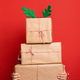 Caucasian boy wearing Christmas reindeer antlers holding pile of christmas gifts. Caucasian boy wearing Christmas reindeer antlers holding pile of christmas gifts. - PhotoDune Item for Sale